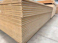 Stack of plywood sheets in a warehouse on a concrete floor, construction material