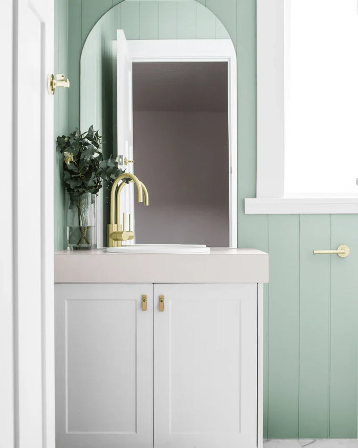 Bathroom feature wall lined with painted VJ panels behind a freestanding vanity