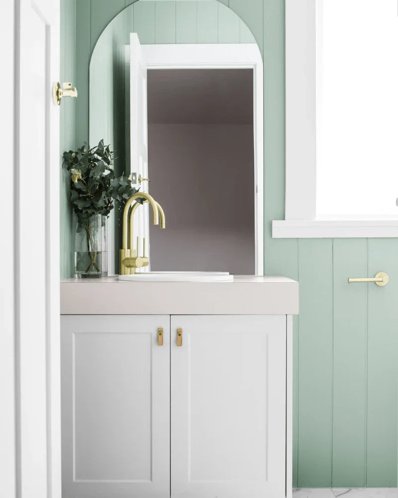 Bathroom feature wall lined with painted VJ panels behind a freestanding vanity